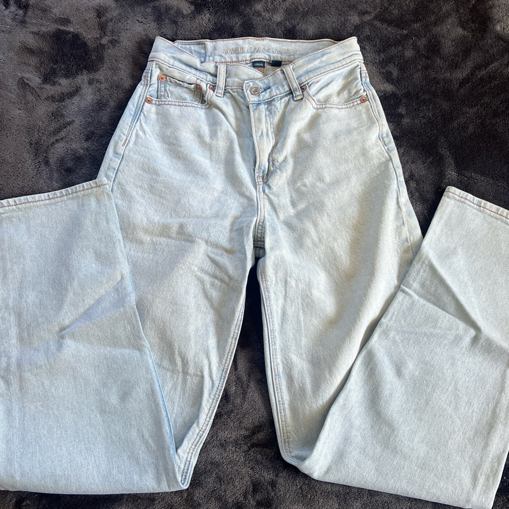 American Eagle light wash jeans with asymmetric button closure